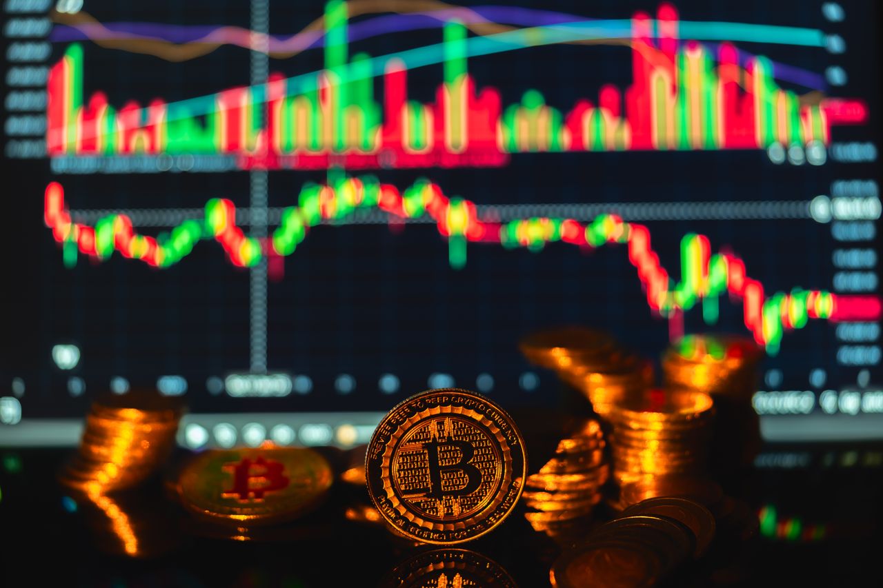 Golden Bitcoin coins in front of a financial graph, symbolizing cryptocurrency market trends.